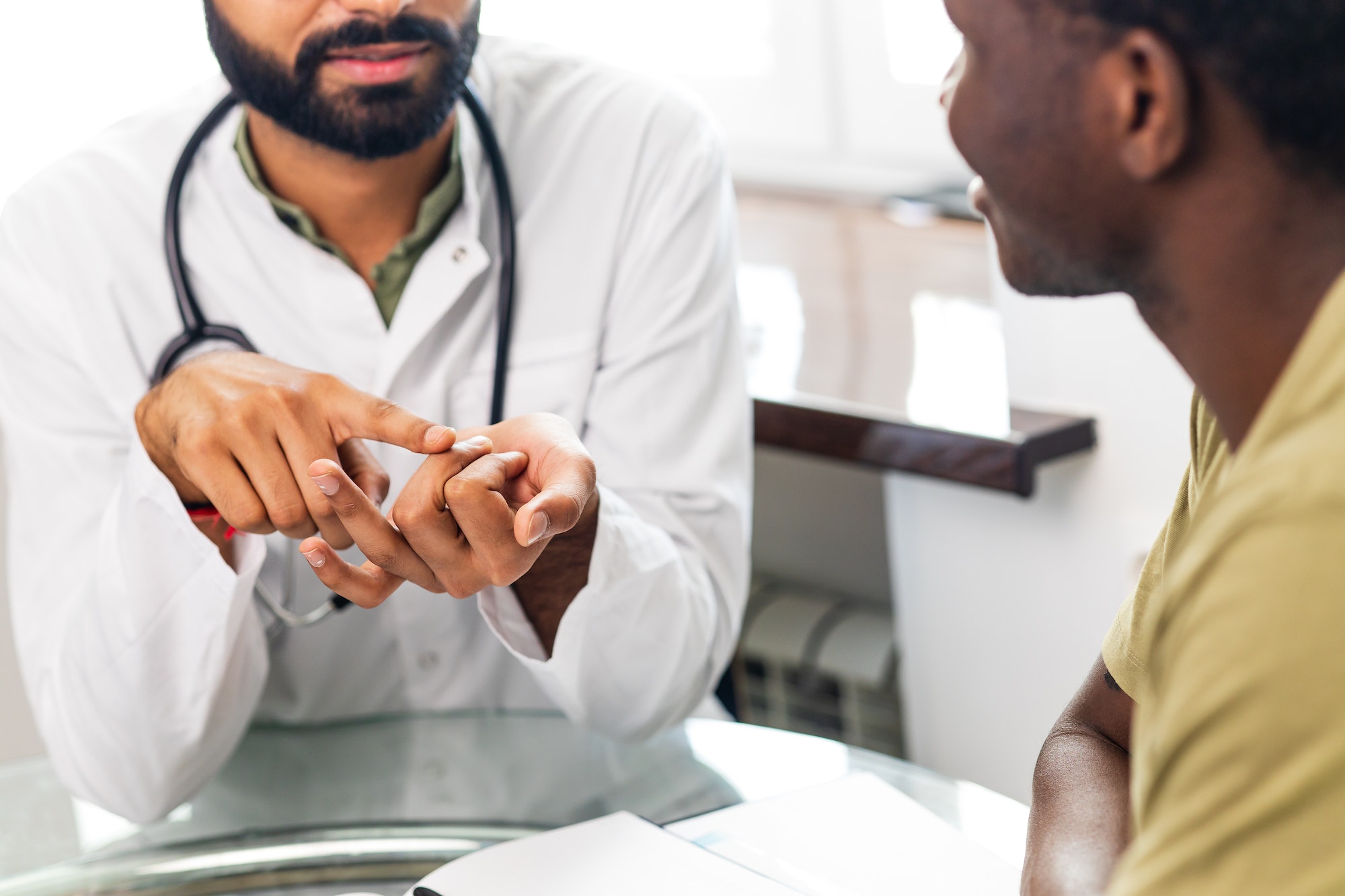 doctor and male patient talking at office consultation for further treatment