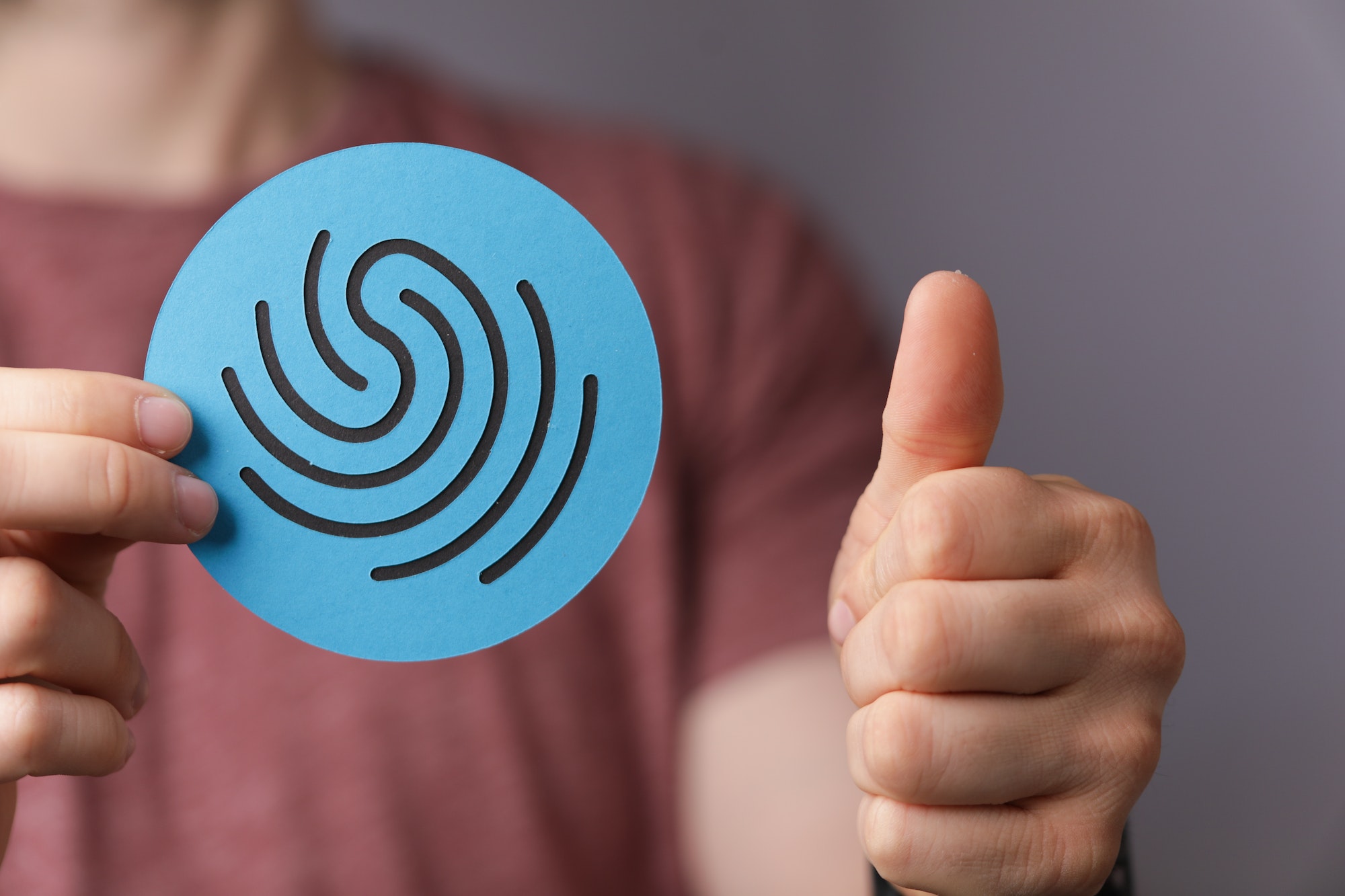 Man holding a sign of a fingerprint- the concept of privacy